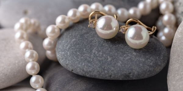 Akoya-pearl-earrings-and-necklace-on-stacked-grey-stones display