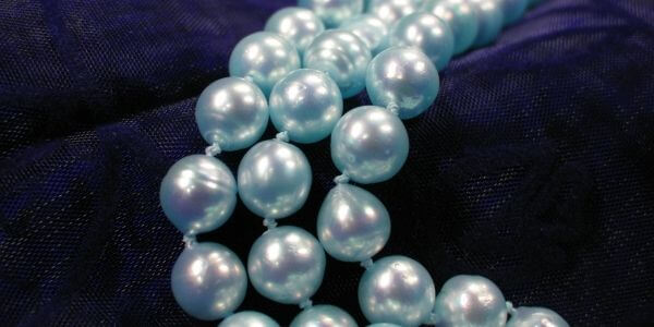 blue akoya pearls necklaces on black background