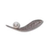 single pearl sitting on a silver leaf desiign brooch